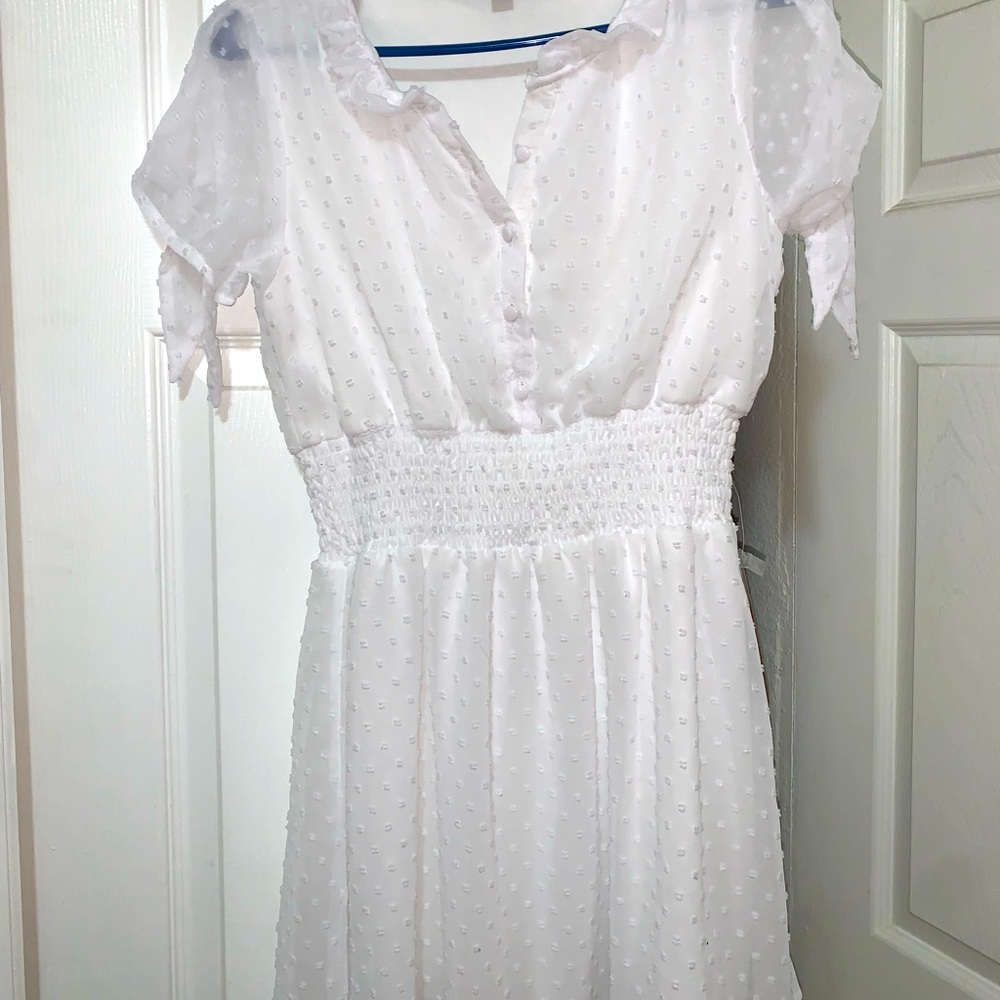 White short dress woth small details.